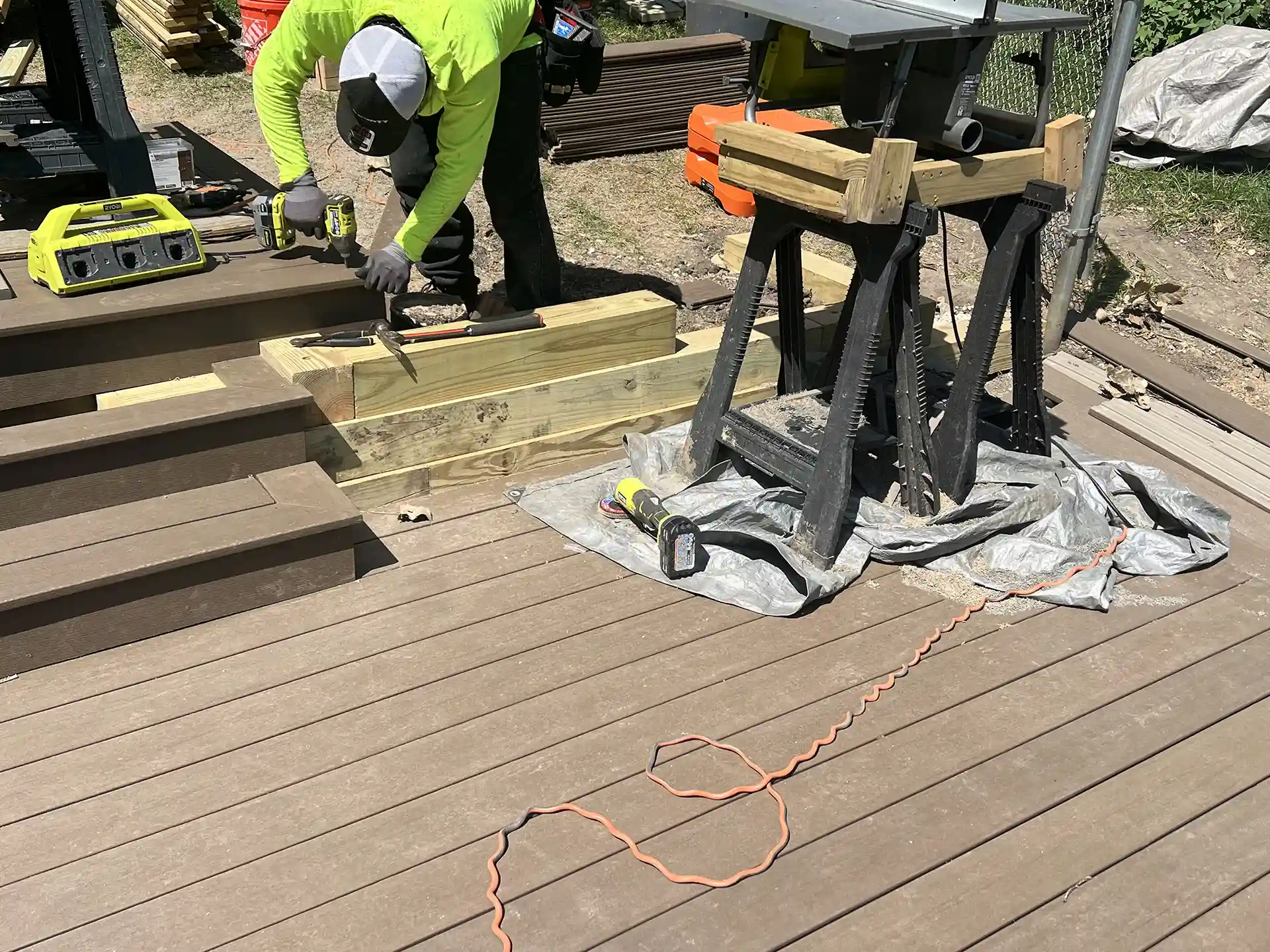photo of a deck builder creating a custom deck with high quality materials 