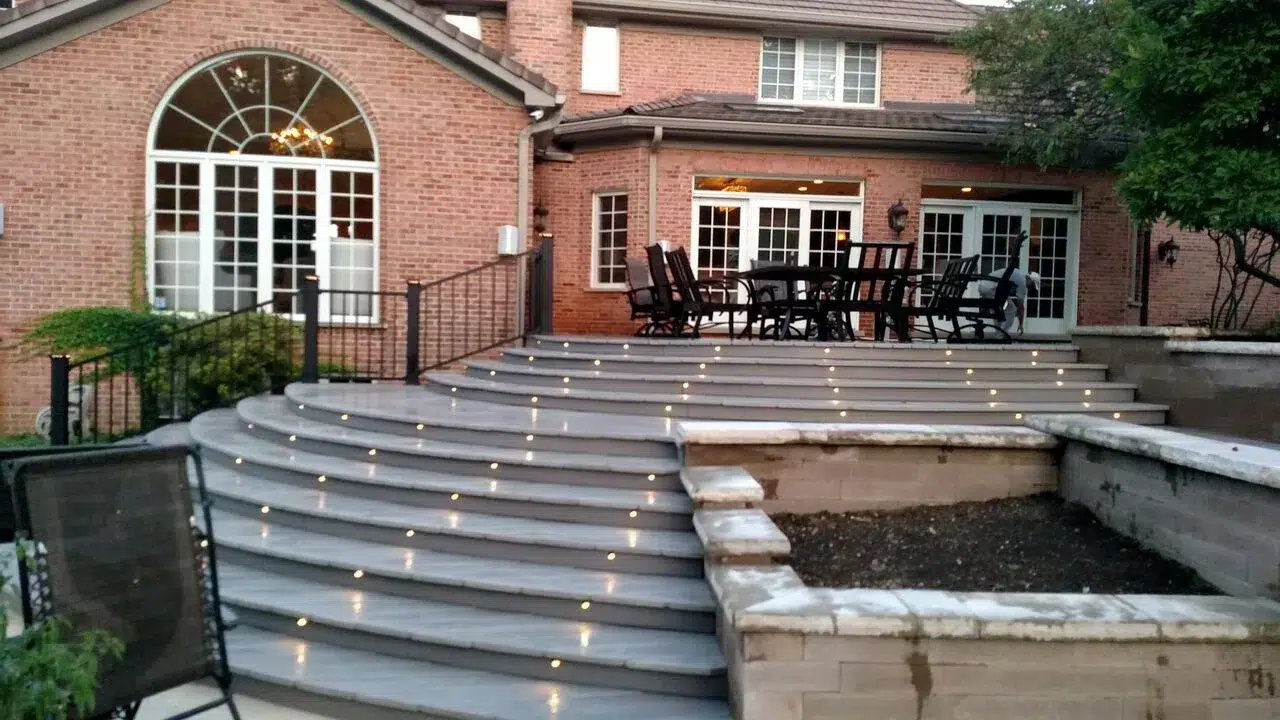 Photo of a custom deck with in-step deck lighting, a deck design trend